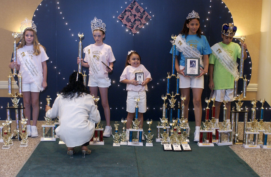  Carrasquillo's group stands with their trophies, crowns and plaques after competing in the 2005 Sweet Pea Pageants National Finals in Cocoa Beach.   : Little Miss Sweet Pea : Madison | Milwaukee | Chicago | Writer | Photographer | Keri Wiginton | Portrait photography | Travel | Corporate | Photojournalist | Editorial | Environmental