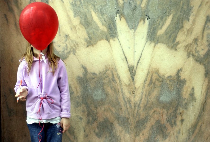 Elizabeth Curley, 10, blows on her balloon while her parents listen to live music during Ybor City's Fiesta Day in Tampa, Fla. : Moments : Madison | Milwaukee | Chicago | Writer | Photographer | Keri Wiginton | Portrait photography | Travel | Corporate | Photojournalist | Editorial | Environmental