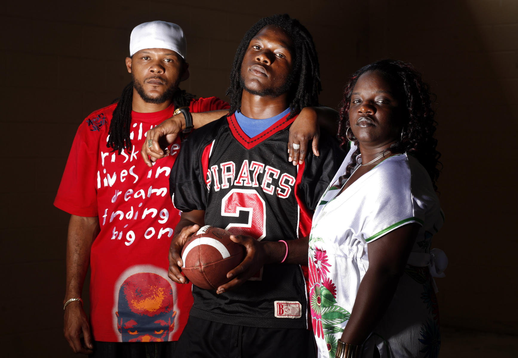 Jamie Byrd, Jr., 17, center, is flanked by his father Jamie Byrd and mother Sierra O'Neal. Byrd is a junior at Pasco High and plays for the Pirates. His father, who also donned the #2 on his jersey, was on the team 17 years ago. : People : Madison | Milwaukee | Chicago | Writer | Photographer | Keri Wiginton | Portrait photography | Travel | Corporate | Photojournalist | Editorial | Environmental