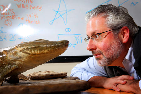 Professor Neil Shubin, author of "The Universe Within," is photographed in his office at the University of Chicago with his discovery Tiktaalik roseae.